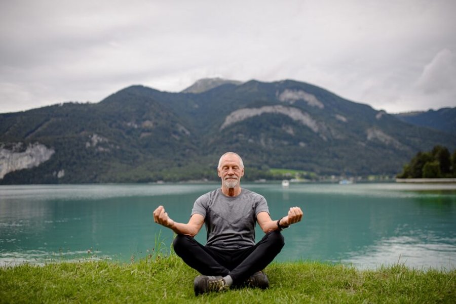 Senior,Man,Doing,Outdoor,Yoga,,Meditating,By,The,Lake,In